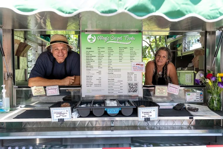 Dean and Deb Varvoutis, co-owners of University City's Magic Carpet Foods, pose for a portrait at their food truck on June 13, two weeks before they retire after 34 years in business.