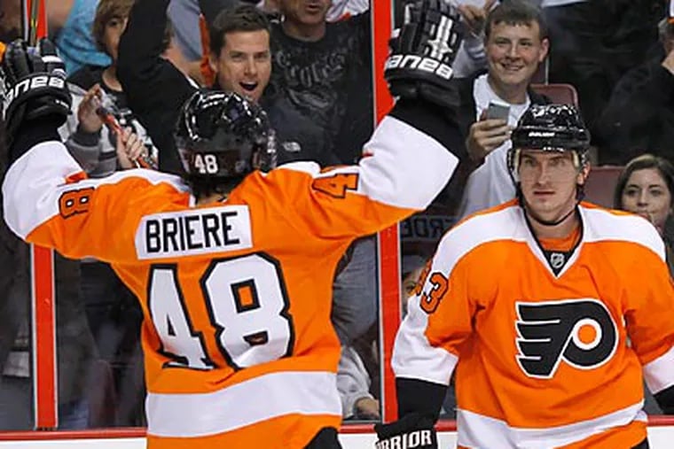 Danny Briere celebrates after Nikolai Zherdev (right) scored a goal in the second period. (Yong Kim/Staff Photographer)