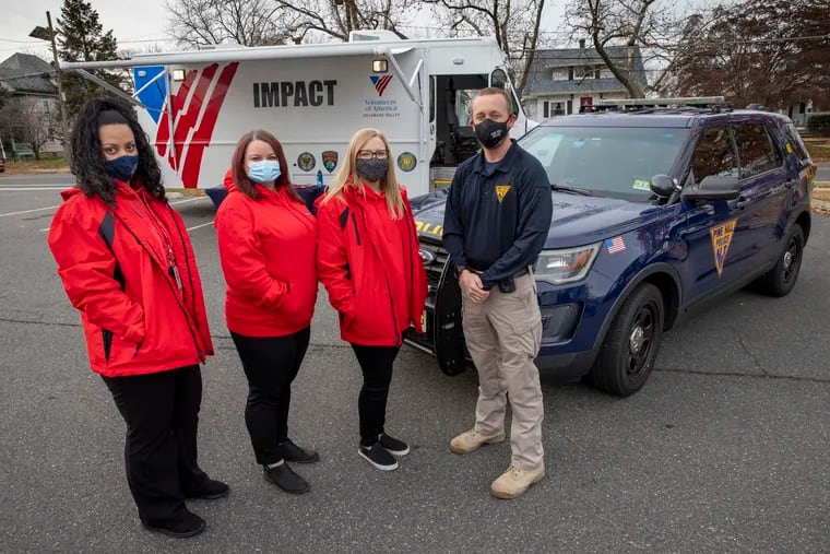 IMPACT members (from left) Autumn Caraballo, Kaitlyn Friess, and Christina Lemma, partner with police officers in Pine Hill, including officer Martin Brennan, to better handle calls for assistance involving mental illness. The IMPACT program uses a co-responder model that pairs police with social workers in an attempt to avoid violence or criminal charges.
