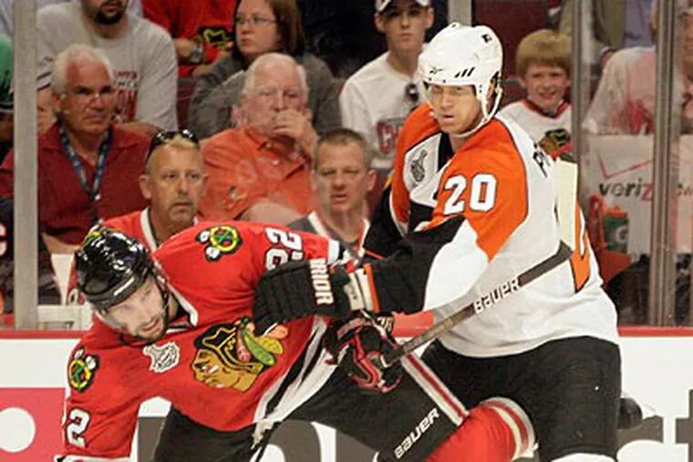 Chris Pronger pushes Blackhawks' Troy Brouwer during the third period of Game 1. (Yong Kim / Staff Photographer)