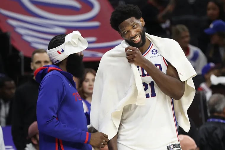 James Harden (left) and Joel Embiid of the Sixers share a laugh during a preseason game on Oct. 12.