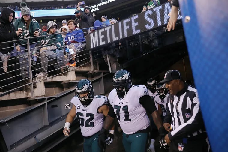 Center Jason Kelce (62) and tackle Jason Peters (71) emerge from the tunnel in what was likely Peters' final regular-season game as an Eagle, against the Giants on Dec. 29  in the Meadowlands.