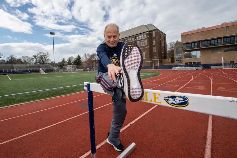 Josh Buch stretches at McCarthy Stadium at La Salle University. Buch will be appearing in his sixth Penn Relays on Saturday, in the masters 100-meter dash for runners 80 and older.