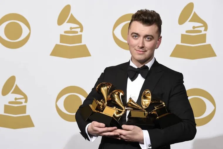 Sam Smith poses in the press room with the awards for best new artist, best pop vocal album for "In the Lonely Hour," song of the year for "Stay With Me," and record of the year for "Stay With Me" at the 57th annual Grammy Awards at the Staples Center on Sunday, Feb. 8, 2015, in Los Angeles. (Photo by Chris Pizzello/Invision/AP)