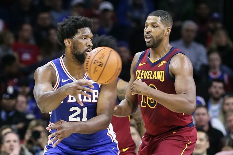Sixers' Joel Embiid throws a pass in front of Cavaliers' Tristan Thompson during the 1st  quarter at the Wells Fargo Center in Philadelphia, Tuesday, November 12, 2019.