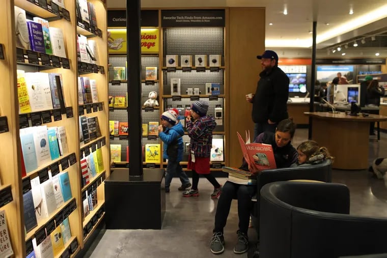 Allyson reads to her daughter Claire during a soft opening of Chicago's first Amazon store on Saturday, March 18.