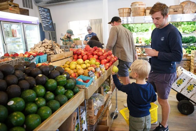 Patrick Bates-Brennan and son Carrick shop at Riverwards produce in Philadelphia, Friday, Sept. 1, 2017. A number of shops and delivery services that sell fresh produce are popping up to meet an increased demand of consumers.
