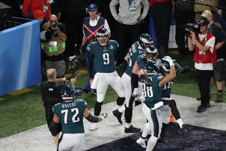 Nick Foles and his teammates go wild after the quarterback scored on a pass from tight end Trey Burton with 34 seconds left in the first half of Super Bowl 52.