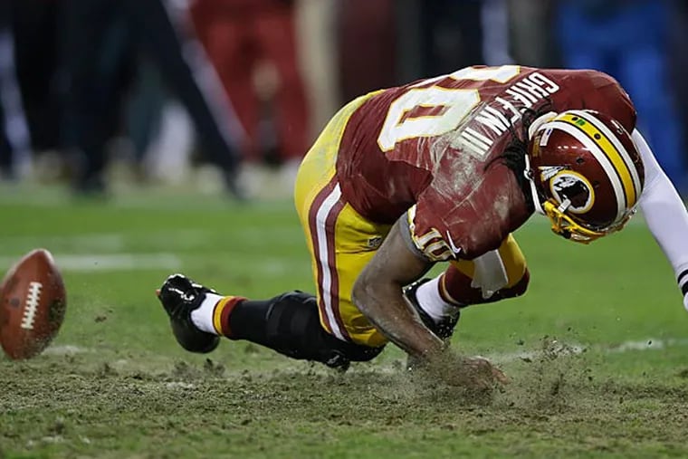 It doesn't sound good for Robert Griffin III.  An injury that may sideline RGIII well into next season is a very real possibility. (Matt Slocum/AP)