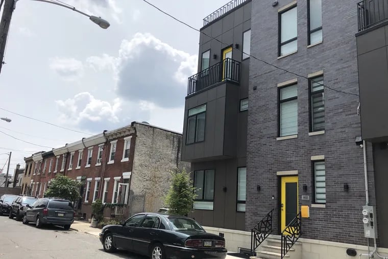 At the corner of Carlisle Street and Ellsworth in Point Breeze, one neighborhood at the center of Philly's gentrification debates, modern-style townhouses are next to traditional brick rowhomes.