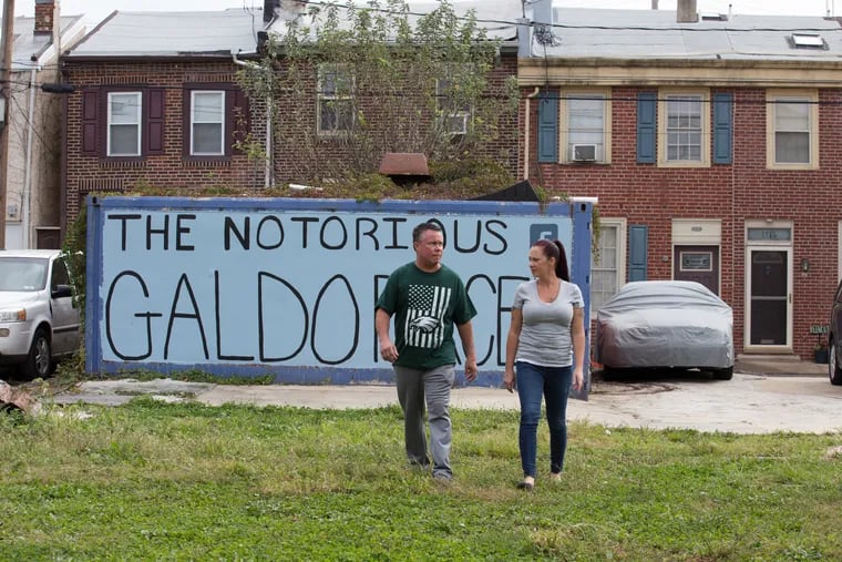 Frank Galdo (left) and his wife, Nicole, in 2017 on the lot Frank maintained in Fishtown for nearly three decades. After a long court fight, the Pennsylvania Supreme Court ruled Thursday in Galdo's favor.