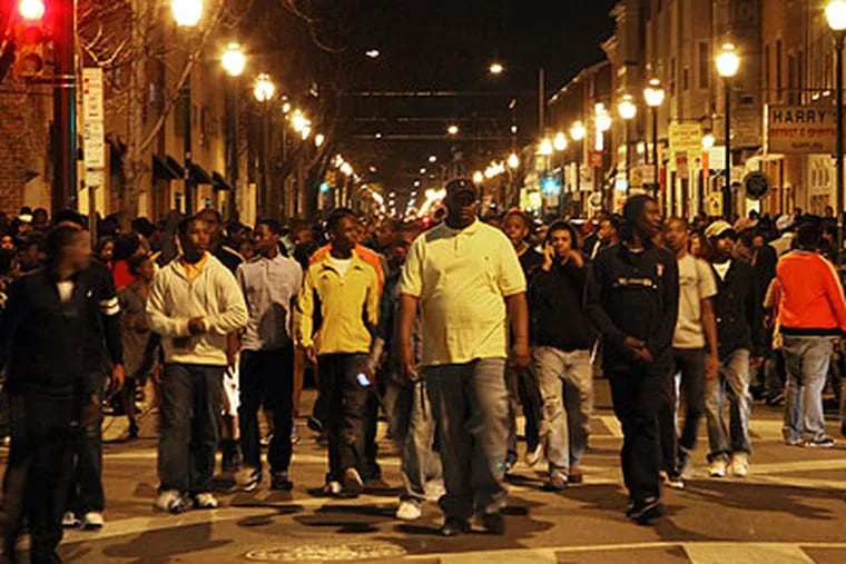 Young people fill South Street at 11:15 pm during a flash mob incident that involved thousands and closed the street to traffic from Front Street to Broad Street in Philadelphia on Saturday night, March 20, 2010. (Laurence Kesterson / Staff Photographer)