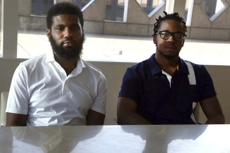 Rashon Nelson, left, and Donte Robinson, right, both 23, sit in their attorney’s conference room after an April 18 interview with the Associated Press.