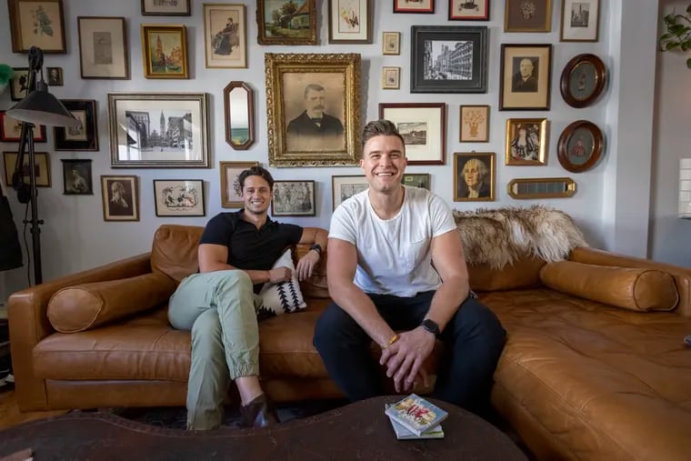 Zach Boyers (left) created a gallery style photo wall with a Victorian era theme in the home he shares with Hugh Blanchetti in Manayunk. Two pictures are of Blanchetti’s relatives, and there are a few George Washingtons because Blanchetti is from Virginia.