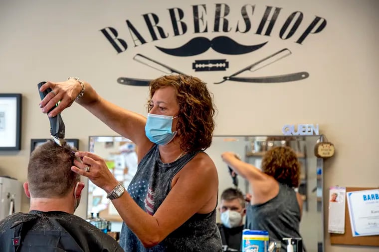 Barber Karen Dupuy cuts the hair of Jack Peffer of Audubon at Haddon Township Barber Shop on Monday, the first day salons and other personal-care businesses could reopen in New Jersey amid the coronavirus pandemic.