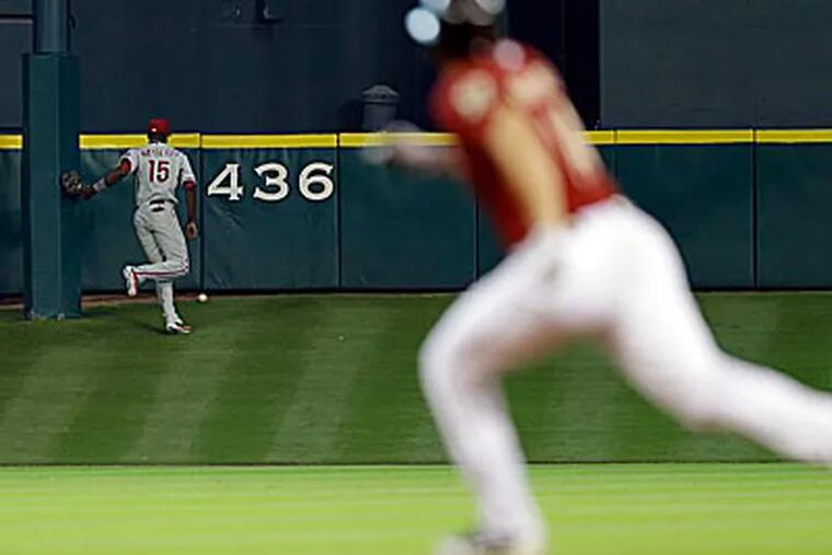 Phillies centerfielder John Mayberry tracks down  J.D. Martinez's triple in the second inning of Sunday's loss. (David J. Phillip/AP)