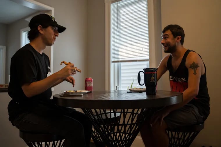 Michael Franolich, 25, (left) and Zack Pastore, 23, enjoy conversation while eating their pizza for lunch in Collingswood. Michael, who  is on the autism spectrum, and Zack who was diagnosed with aspergers syndrome, have been placed in a job and home in Collingswood by the JEVS Independence Network.