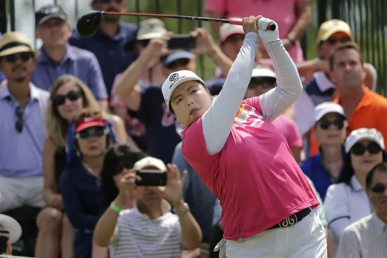 China’s Shanshan Feng tees off the first hole during the third round of the U.S. Women’s Open Golf tournament, Saturday.