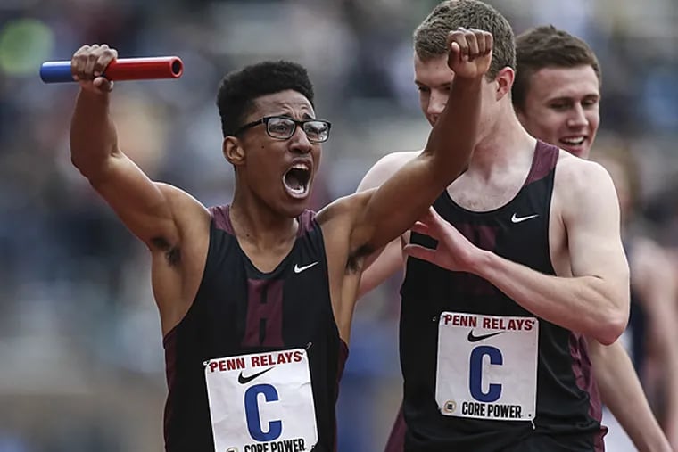 Henderson's Tony Russell (left) celebrates after a race at the Penn Relays in April. (Steven M. Falk/Staff Photographer)