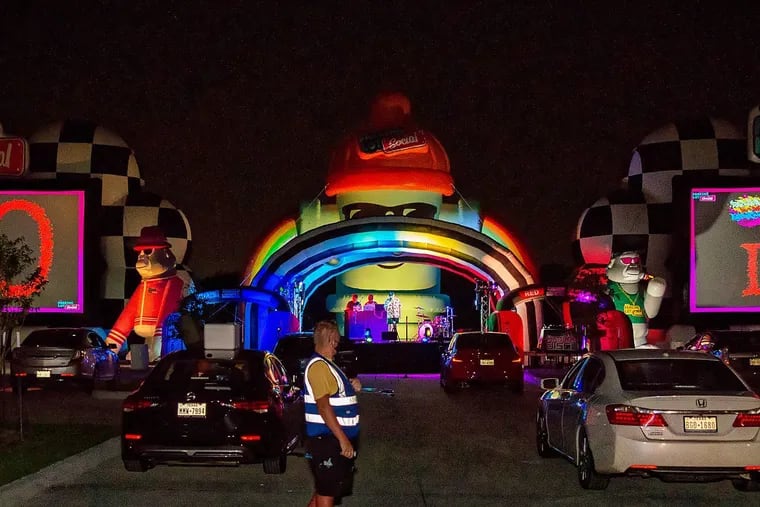 Two 40-foot movie screens appear on either side of the main stage at The Parking Lot Social in Houston last month. Directly behind the stage is a 52-foot inflatable fire hydrant with rainbows.