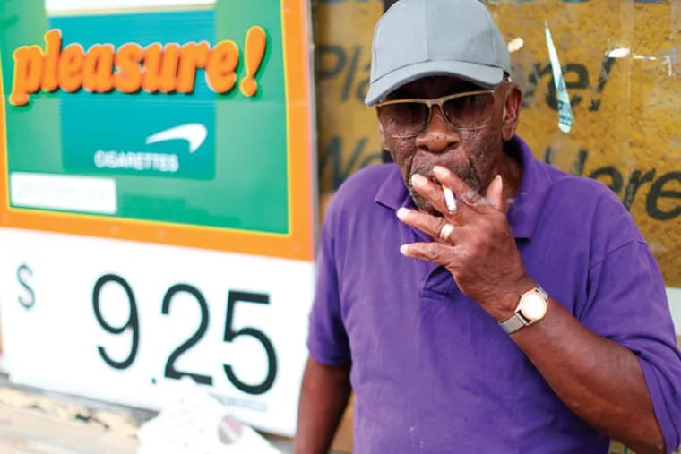 James W. Mitchell smokes at 40th and Market Street Wednesday. (DAVID SWANSON / Staff Photographer)