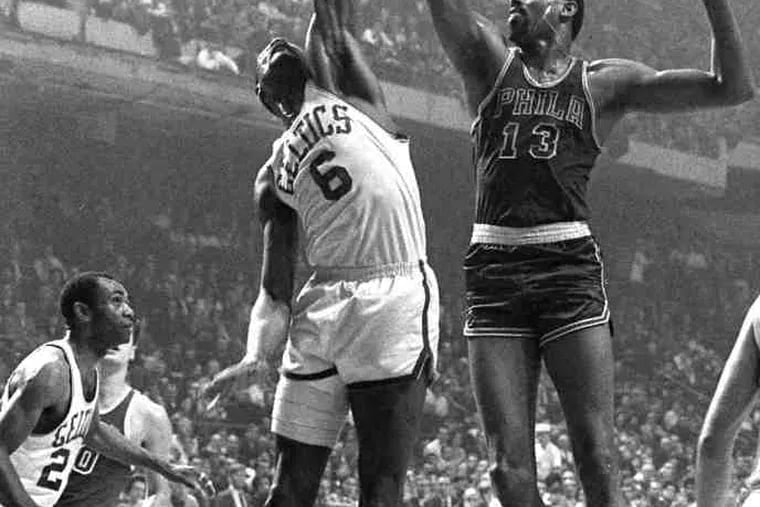 Celtics' Bill Russell (left) and Sixers' Wilt Chamberlain battle for rebound during game in January, 1967.