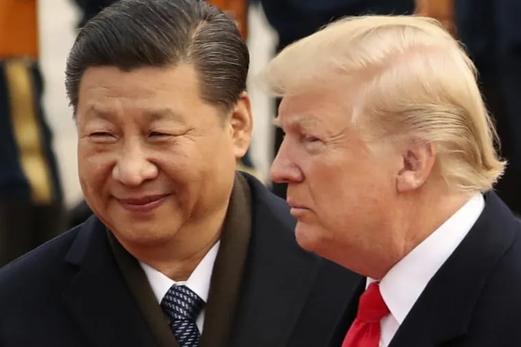 FILE – In this Nov. 9, 2017, file photo, U.S. President Donald Trump and Chinese President Xi Jinping participate in a welcome ceremony at the Great Hall of the People in Beijing, China. Xi had an "extremely positive" phone conversation with Trump about trade and other issues, the foreign ministry said Friday, Nov. 2, 2018. The two leaders agreed to "strengthen economic exchanges," said a ministry spokesman, Lu Kang. (AP Photo/Andrew Harnik, File)