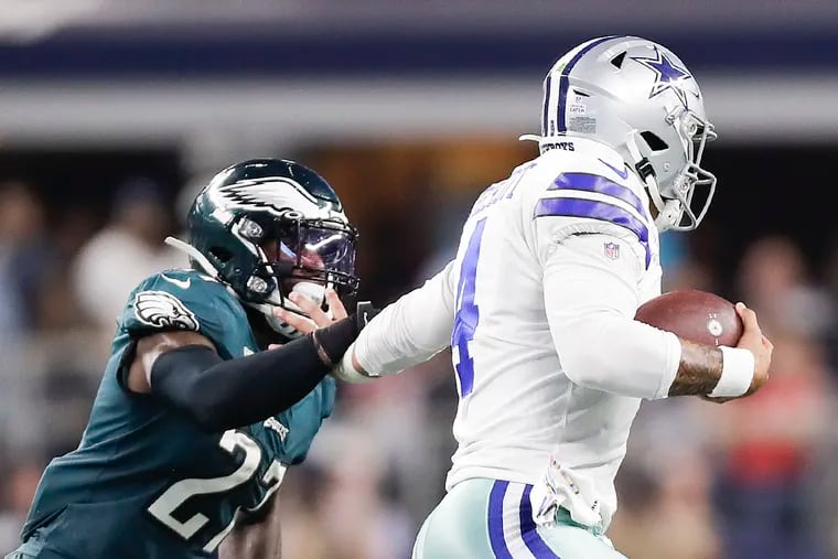 Dallas Cowboys quarterback Dak Prescott runs with the football against Eagles strong safety Malcolm Jenkins during the third-quarter on Sunday, October 20, 2019 in Arlington, TX.