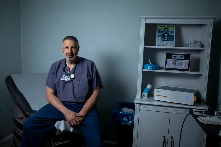 Stephen Borgese, a physician at Forge Medical Group, poses for a portrait next to the Storz D-Actor 100, which he uses to help patients with erectile dysfunction in Bryn Mawr. He has treated more than 700 patients in the last three years.