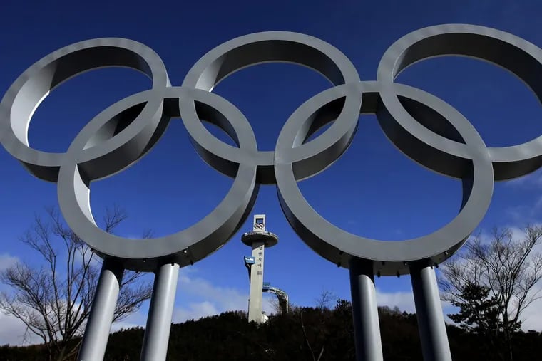 The tower for the Alpensia Ski Jumping Center rises beyond a set of Olympic Rings at the 2018 Winter Olympics in Pyeongchang, South Korea.