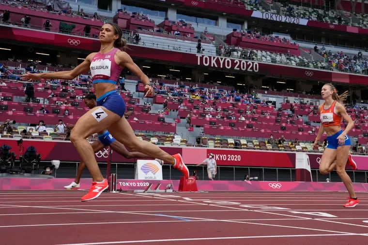 Sydney McLaughlin, left, crosses the finish line in the women's 400-meter hurdles final.
