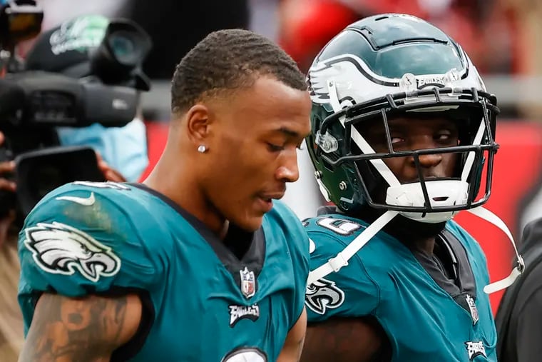 Eagles wide receiver Jalen Reagor looks over at teammate  wide receiver DeVonta Smith while they walk-off the field after losing to the Tampa Bay Buccaneers in a NFC Wildcard playoff game on Sunday, January 16, 2022 in Tampa Bay.
