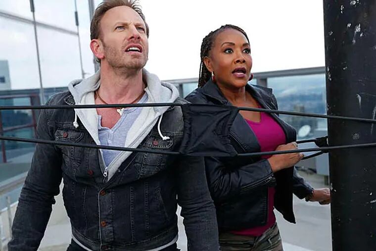 You don't usually look up and see sharks, but this is "Sharknado 2" and that's exactly what Ian Ziering and Vivica A. Fox are doing.