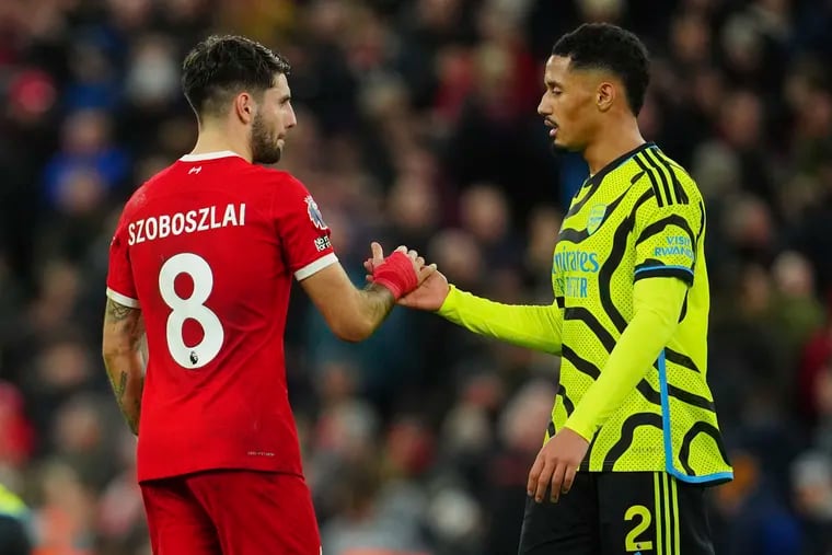 Liverpool's Dominik Szoboszlai (left) and Arsenal's William Saliba (right) shake hands after they faced off last December.