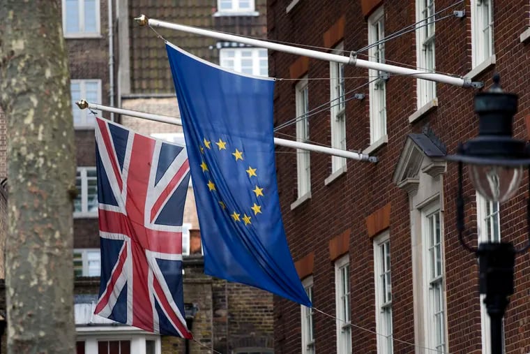 The flags of Britain and the European Union outside Europe House, the European Parliament's offices in London.British voters chose to leave the EU in a referendum on Thursday. MATT DUNHAM / AP