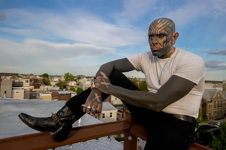 Richie Grossman is shown on the rooftop deck of his home and studio on May 5, 2022. The blackout tattoo is spreading like an ink stain out of a Girard Avenue tattoo parlor.