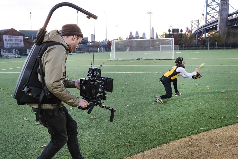 Director of Photography Nathan Podshadley films Junettsi Ayana Martinez during softball practice.