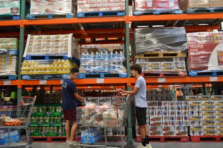 Food4Philly cofounders Ethan Chan (left) and Zaid Salaria (right) shopping for food at a Costco in September 2022, ahead of upcoming food drives.
