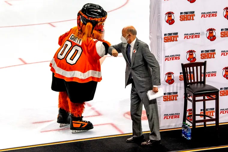 Gov. Tom Wolf elbow bumps Gritty on the ice while he joins the Philadelphia Flyers organization at the Wells Fargo Center.