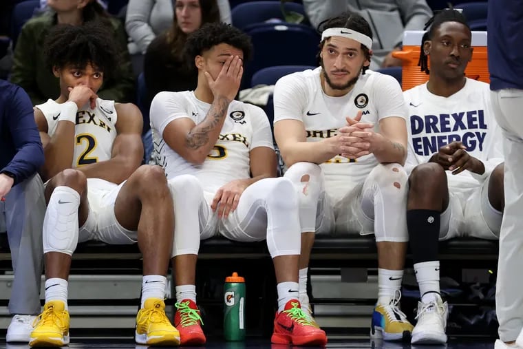 L-R: Lucas Monroe, Jamie Bergens, and Garfield Turner of Drexel sit dejected in the final moments of their double overtime loss to Stony Brook in their CAA tournament quarterfinal game on March 10, 2024.