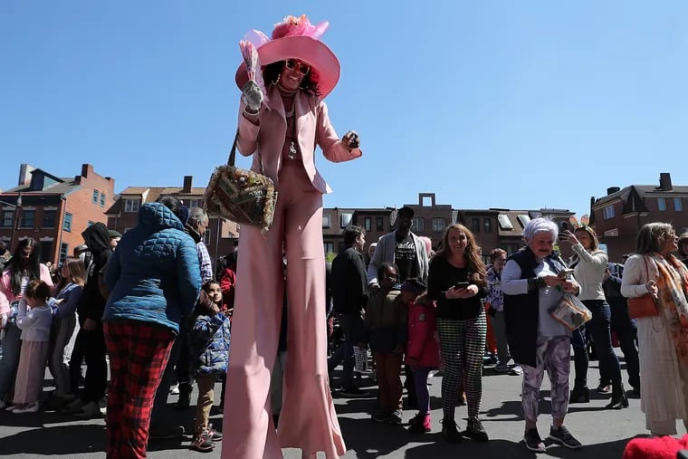 Mafalda Thomas-Bouzy, 59, of Southwest Philadelphia, towers over spectators at the South Street Headhouse District’s 90th Easter Promenade in April.