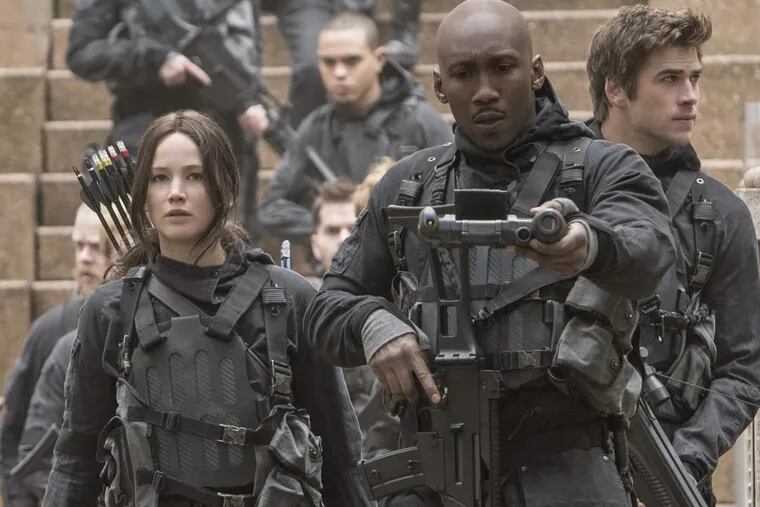 This image released by Lionsgate shows Jennifer Lawrence as Katniss Everdeen, from left, Mahershala Ali as Boggs, and Liam Hemsworth Gale Hawthorne in a scene from “The hunger Games: Mockingjay Part 2.”
