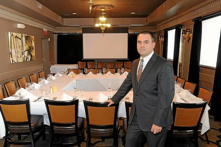 Dean Vagnozzi stands in a room at Ruth Chris Steakhouse in King of Prussia, where he has pitched people during dinners about potential "alternative" investments.