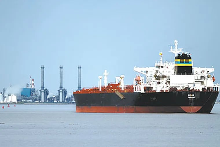 A tanker heads up the Delaware River toward Marcus Hook and Trainer from Delaware. (David Swanson / Staff Photographer)