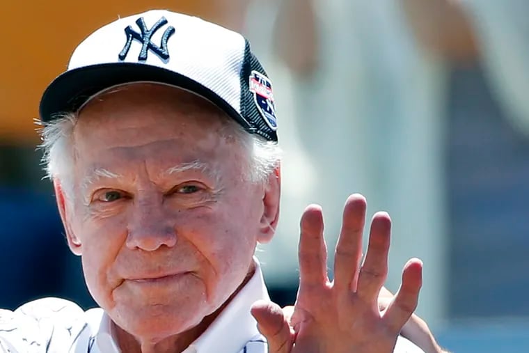 In this June 12, 2016 photo, former New York Yankees pitcher Whitey Ford waved to fans from outside the dugout at the Yankees' annual Old Timers Day game in New York.