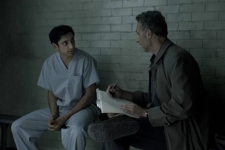 Riz Ahmed (left) and John Turturro in a scene from HBO's "The Night Of," which begins Sunday