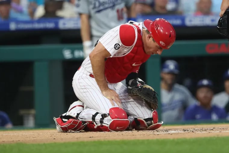 J.T. Realmuto of the Phillies was hit by a foul ball by Max Muncy of the Dodgers in the first inning.