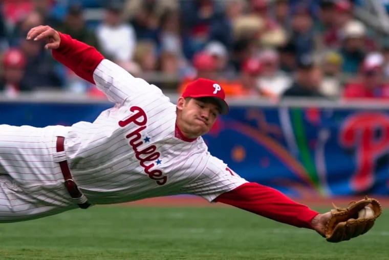 A four-time Gold Glove winner for the Phillies, third baseman Scott Rolen makes a diving catch against the Cubs on April 6, 2001.