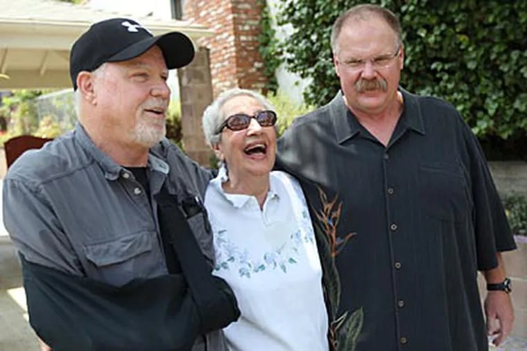 Andy Reid near his old home in Los Angeles with Reba Poor, who babysat him, and his brother. (Michael Bryant/Staff Photographer)