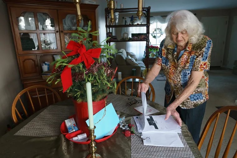 Connie Patrick, shown here with all the papers related to  a charge of $4,650 for services she never received from Repairs R Us, a Philadelphia appliance repair company, she is standing in her home in Feasterville.  JESSICA GRIFFIN / Staff Photographer